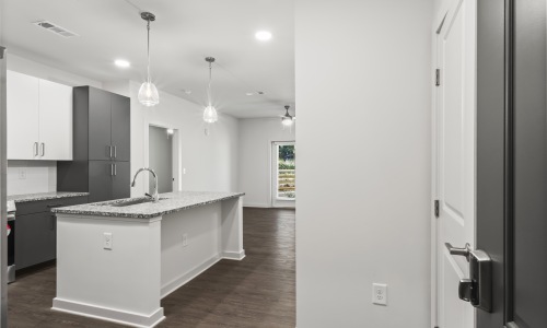 Kitchen with wood-like flooring, granite countertops, and energy-efficient light fixtures